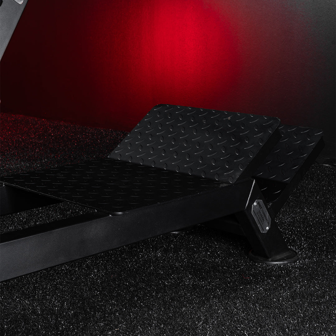 Black metal platform with textured surface on a dark background